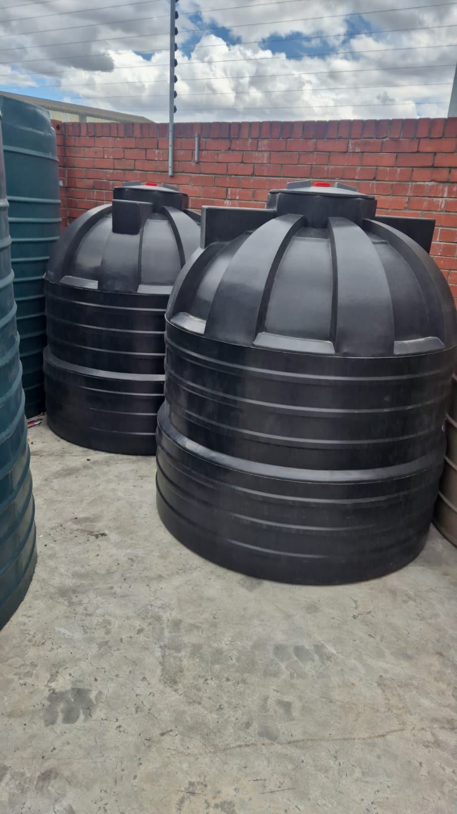 Black Makulu septic tanks in the factory yard